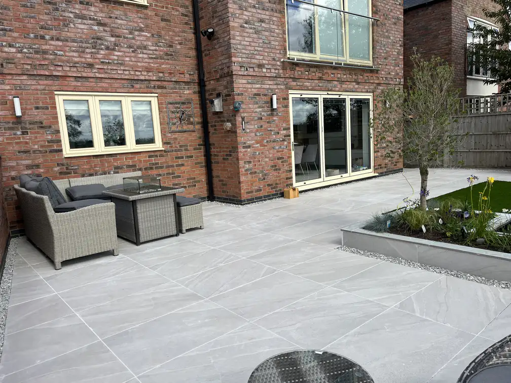 Spacious porcelain patio hosting a full outdoor sofa set, an entertaining terrace with room for the whole family.