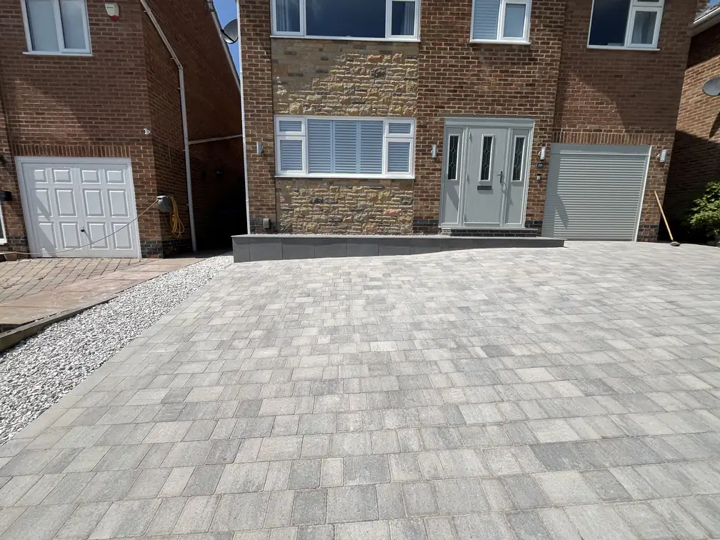 Block paving driveway with raised porcelain entrance plinth, a clean contemporary upgrade to this frontage.