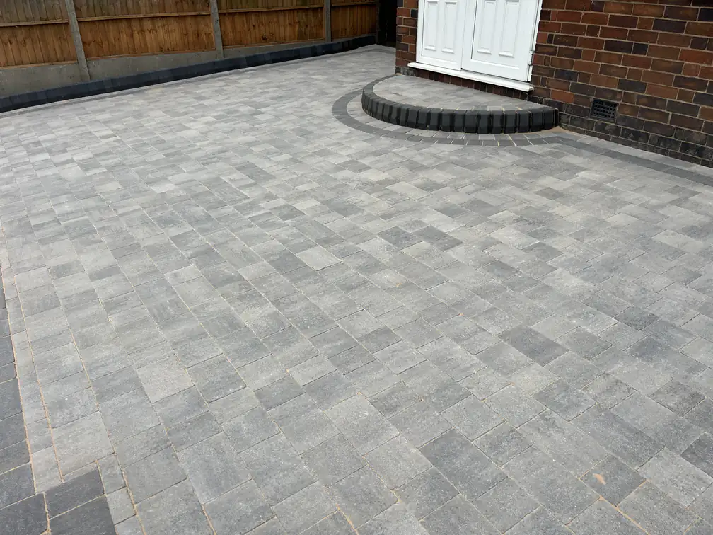 Block paved rear yard with semicircle entrance step at a period brick home, tidy hard-wearing access all year.