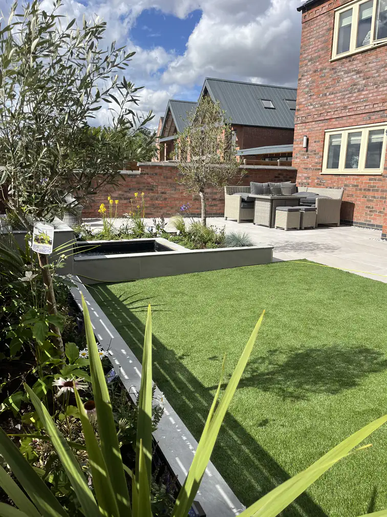 Large-format porcelain paving laid across a full garden terrace, a seamless low-maintenance entertaining surface.
